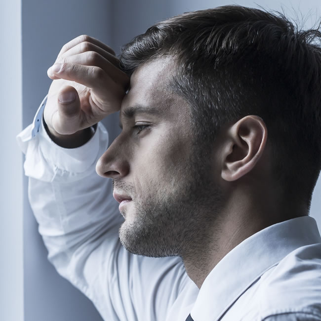 Anxiety hypnotherapy in Medway Kent – man looking stressed at window